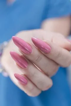 Hands with long nails and light pink manicure Photos