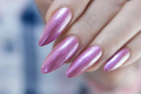 Hands with long nails and light pink manicure Stock Photos