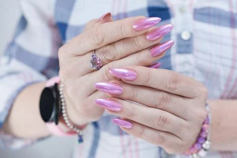 Hands with long nails and a light pink color nail polish Stock Photos