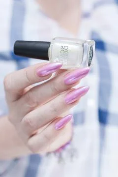 Hands with long nails and light pink manicure 写真素材