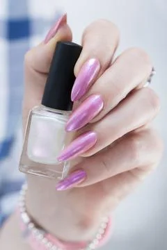 Hands with long nails and a light pink color nail polish 스톡 사진