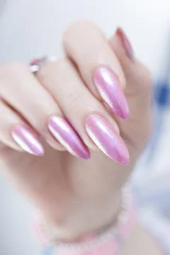 Hands with long nails and light pink manicure Stock Photos