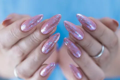 Hands with long nails and a light pink color nail polish Stock Photos
