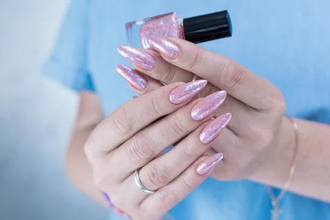 Hands with long nails and a light pink color nail polish Stock Photos