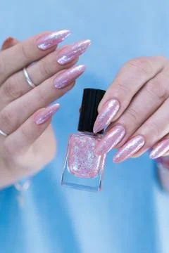 Hands with long nails and a light pink color nail polish Stock Photos