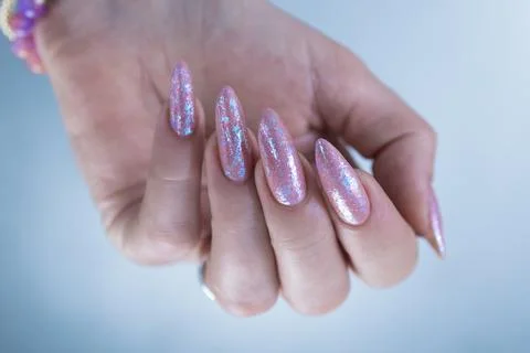 Hands with long nails and a light pink color nail polish Stock Photos