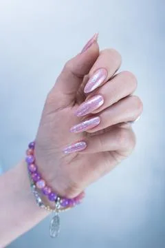 Hands with long nails and a light pink color nail polish Stock Photos