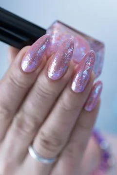 Hands with long nails and a light pink color nail polish 스톡 사진