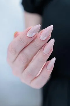 Hands with long nails and a light pink color nail polish Stock Photos