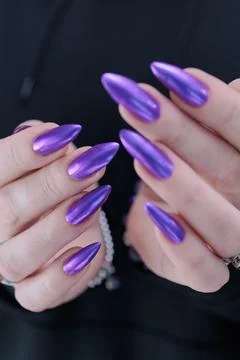 Hands with long nails and purple manicure 스톡 사진