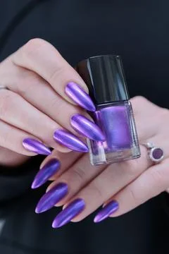 Hands with long nails and purple manicure Stock Photos