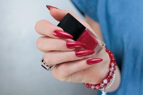 Hands with long nails and red nail polish Фото