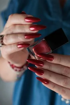 Hands with long nails and red nail polish Stock Photos