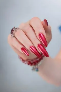 Hands with long nails and red nail polish 스톡 사진
