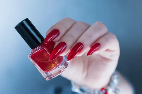 Hands with long nails and red nail polish Stock Photos