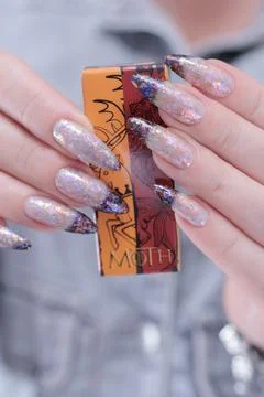 Hands with long nails and white and black thermo french manicure Stock Photos