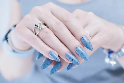 Hands with long nails light gray blue manicure Stock Photos