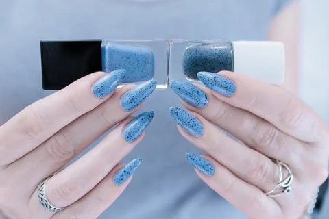 Hands with long nails light gray blue manicure Stock-Fotos