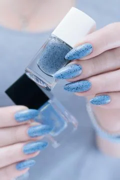 Hands with long nails light gray blue manicure Stock Photos