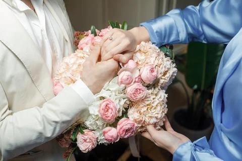 Hands of lovers on a bouquet Stock Photos