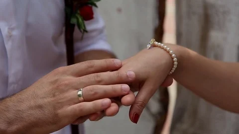 Hands of lovers. Man's hand stroking a woman's hand wearing ancient bracelet. Video stock 69888443