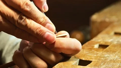 Hands luthier archetier making a new viola bow at workshop workbench Video stock 218113771