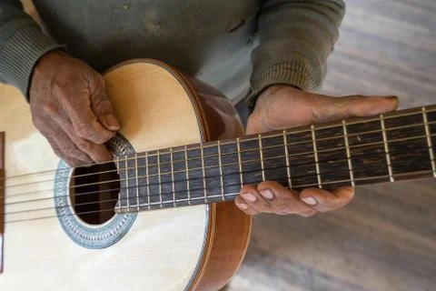 Hands of an luthier holding up a finished classical guitar Stock Photos