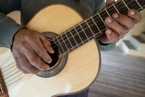Hands of an luthier holding up a finished classical guitar Stock Photos