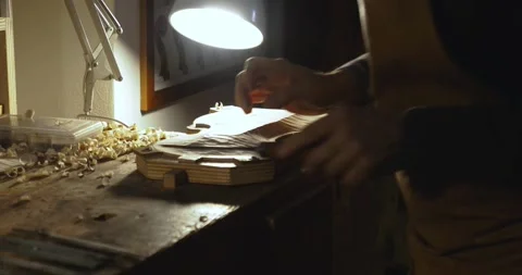 Hands of Luthier violin maker artisan carving wood for crafting violin belly top Stock Footage 300389174