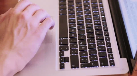 Hands on a Macbook on a wooden table Stock Footage 40357548