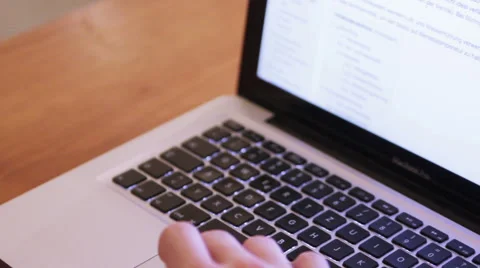 Hands on an Macbook on a wooden table Stock Footage 40359166