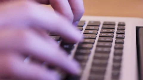 Hands on an Macbook on a wooden table Stock Footage 40359496