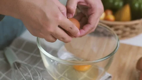 Hands made cracked fresh egg yolks dripping into the bowl. Homemade food Stock Footage 242227986