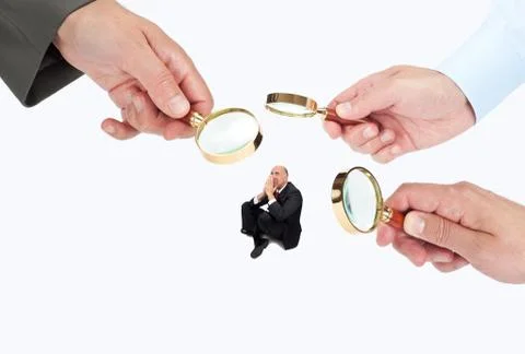 Hands with magnifier glasses looking, studying or selecting a person Stock Photos