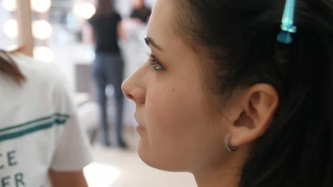 Hands make-up artist applied makeup on the face of a young woman. Girl doing eye Stock Footage 107278415