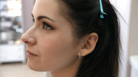 Hands make-up artist applied makeup on the face of a young woman. Girl doing eye Stock Footage 107278595