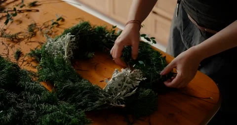 The hands a make a Christmas wreath The process of creating Christmas decoration Stock Footage 259174898