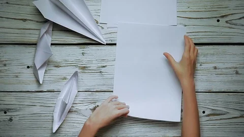 Hands make a paper airplane Stock Footage 81775358