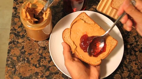 Hands make peanut butter and jelly sandwich Video stock 45524410