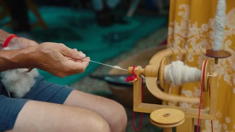 Hands make string from cotton Stock Footage 251187120
