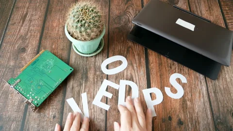 Hands make the word Devops near laptop and motherborad. DevOps Concept  Video stock 122418590