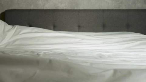 Hands making bed in bedroom, close-up. Housekeeping and maid service Video stock 238595758