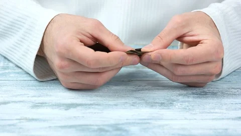 Hands making brown origami shape, close up. Stock Footage 93287738