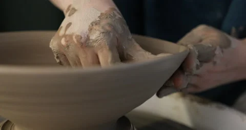Hands making ceramics with clay on pottery wheel with special tools Stock Footage 140767108