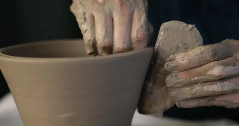 Hands making ceramics with clay on pottery wheel with wooden kidney Stock Footage 140767152