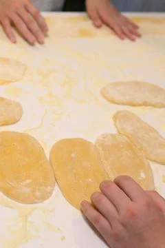 Hands making dough preparing for pasta cooking close up photo Stock-Fotos