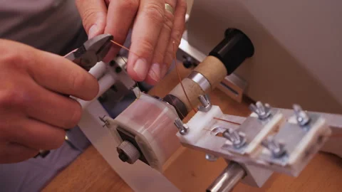 Hands making electronic component - reeling wire on a terminal Stock-Footage 139515136