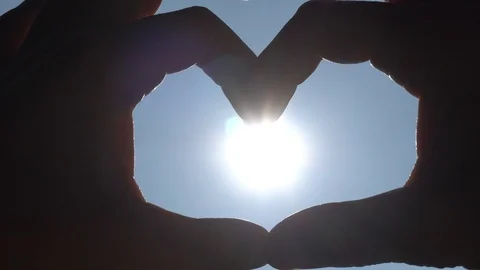 Hands Making Heart Form Backlight, Close Up Stock Footage 96172622