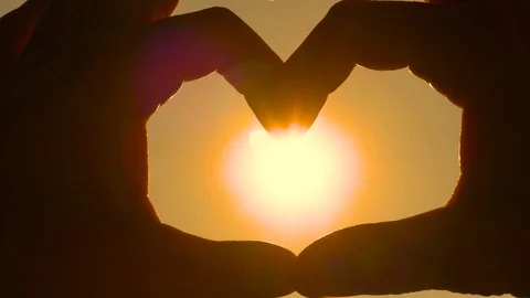 Hands Making Heart Form Backlight at Sunset, Close Up Stock Footage 96179032