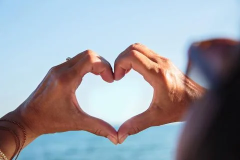 Hands making heart shape framing sky love concept Stock Photos